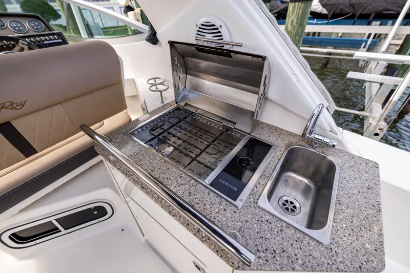 Slide: The Image of Outdoor kitchen on 2016 Sea Ray 310 Sundancer with grill and sink. - 30