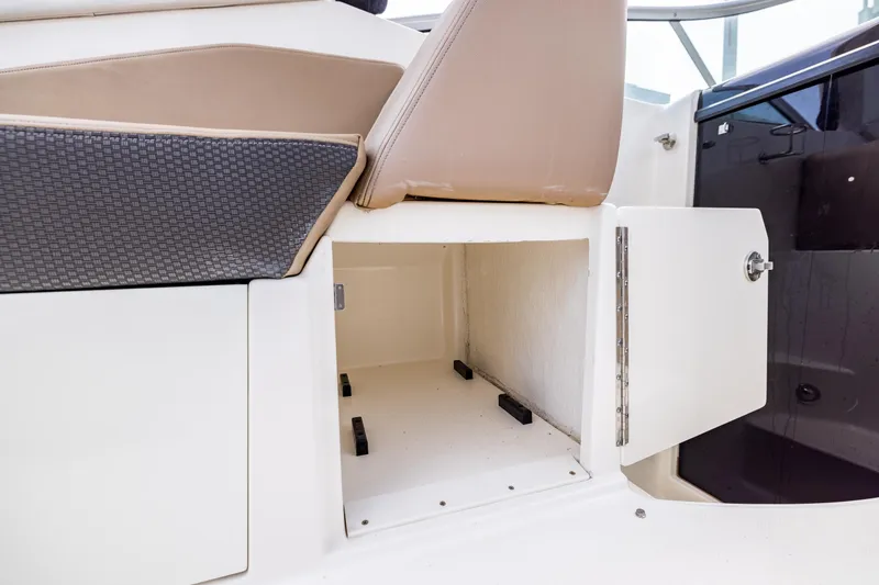 Slide: The Image of Open storage compartment on 2016 Sea Ray 310 Sundancer boat. - 33
