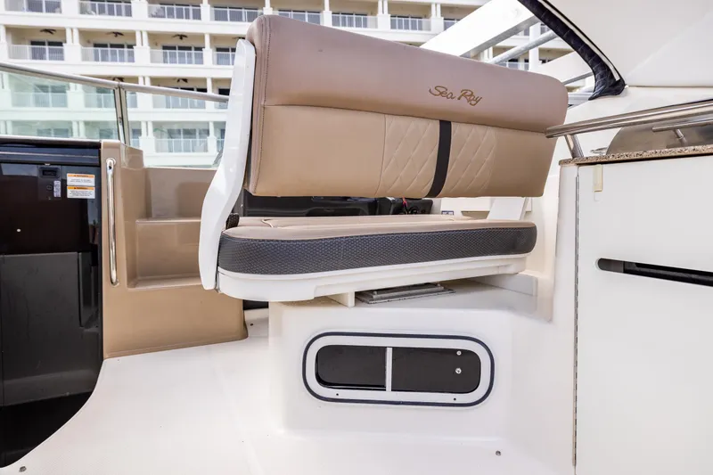 Slide: The Image of 2016 Sea Ray 310 Sundancer interior seating with beige upholstery and modern design. - 34
