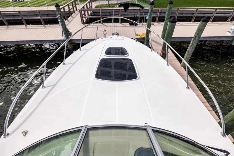Slide: The Image of 2016 Sea Ray 310 Sundancer yacht docked at marina, top deck view. - 38
