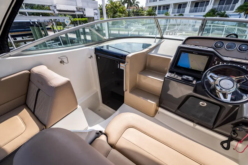Slide: The Image of 2016 Sea Ray 310 Sundancer cockpit with modern navigation system and comfortable seating. - 45