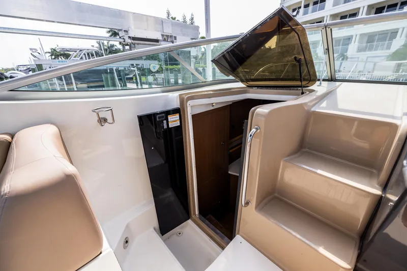 Slide: The Image of 2016 Sea Ray 310 Sundancer cabin entrance with stairs and seating area. - 47