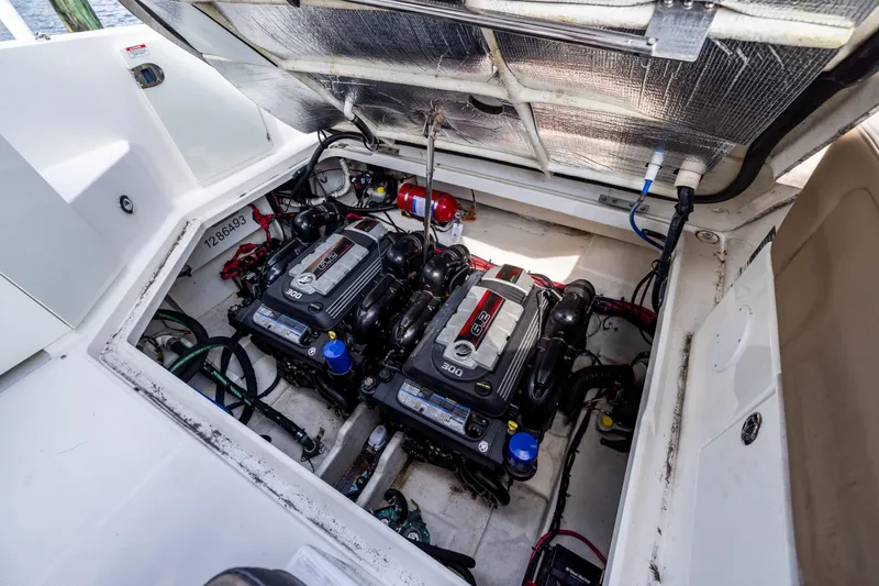 Slide: The Image of Engine compartment of a 2016 Sea Ray 310 Sundancer with twin engines visible. - 48