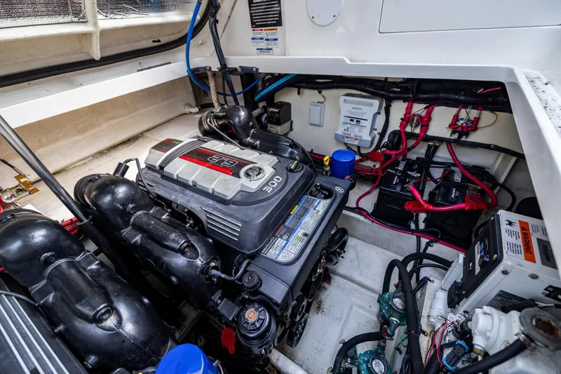 Slide: The Image of Engine compartment of 2016 Sea Ray 310 Sundancer with visible wiring and components. - 49