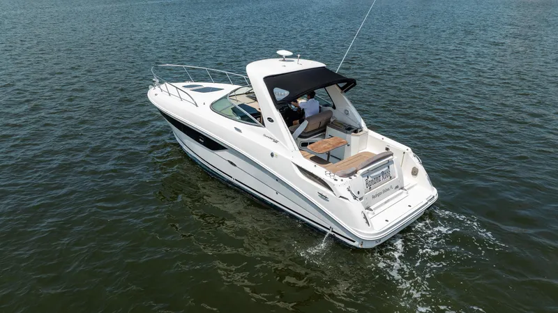 Slide: The Image of 2016 Sea Ray 310 Sundancer cruising on open water. - 7