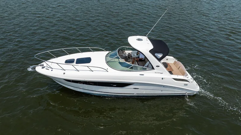 Slide: The Image of 2016 Sea Ray 310 Sundancer cruising on open water, side view. - 8