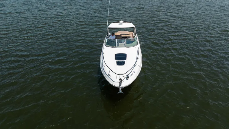 Slide: The Image of 2016 Sea Ray 310 Sundancer cruising on open water, aerial view. - 9