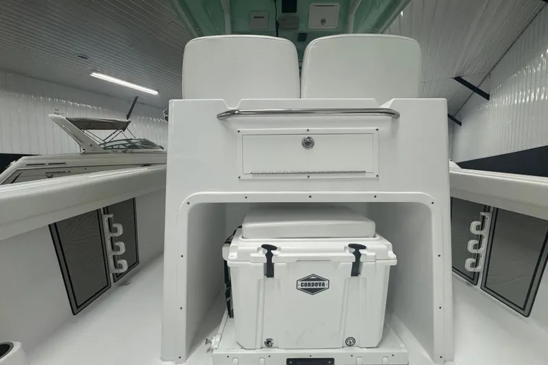 Slide: The Image of 2025 Wellcraft 243 Fisherman boat interior with storage and cooler. - 11