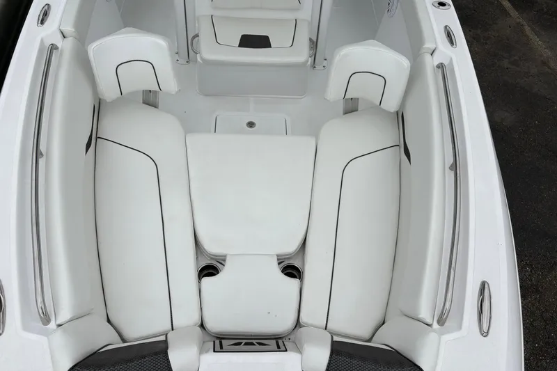 Slide: The Image of 2025 Wellcraft 243 Fisherman boat interior with white cushioned seating and sleek design. - 3