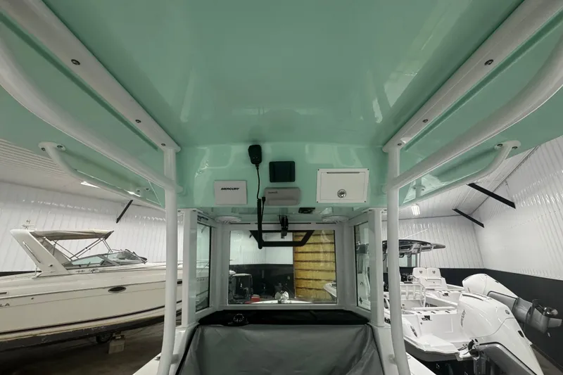 Slide: The Image of Interior view of a 2025 Wellcraft 243 Fisherman boat in a showroom. - 6