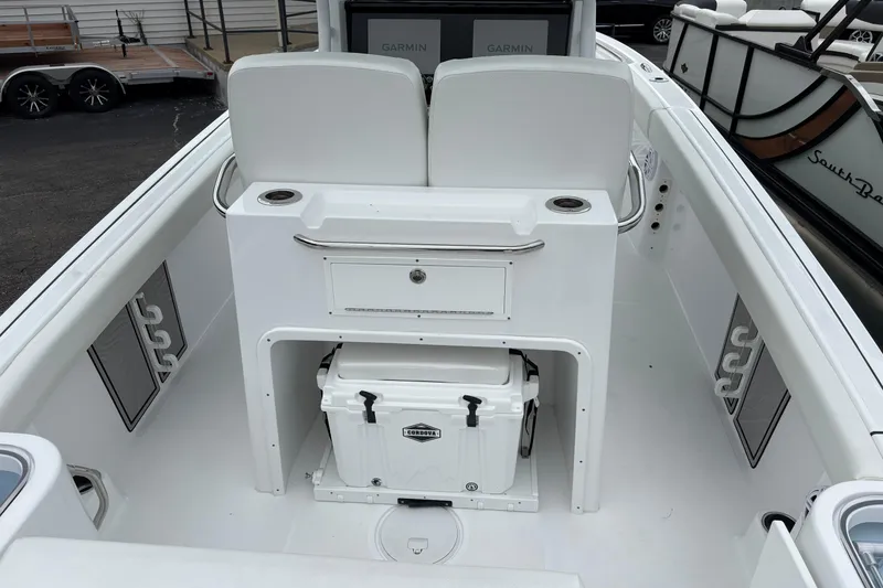 Slide: The Image of 2025 Wellcraft 243 Fisherman boat interior with storage and cooler. - 8