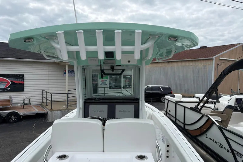 Slide: The Image of 2025 Wellcraft 243 Fisherman boat with Garmin electronics, docked outdoors. - 9