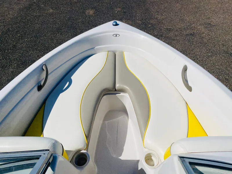 Slide: The Image of 2006 Tahoe Q4 Sport boat interior with white and yellow seating. - 10