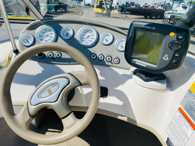 Slide: The Image of 2006 Tahoe Q4 Sport dashboard with steering wheel and Humminbird Fishfinder 535. - 11