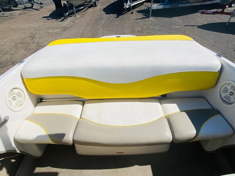 Slide: The Image of 2006 Tahoe Q4 Sport boat interior with yellow and white seating. - 13