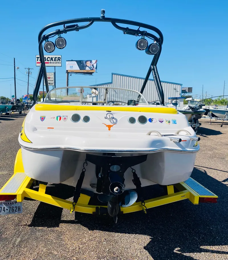 Slide: The Image of 2006 Tahoe Q4 Sport boat on trailer, rear view, sunny day. - 6