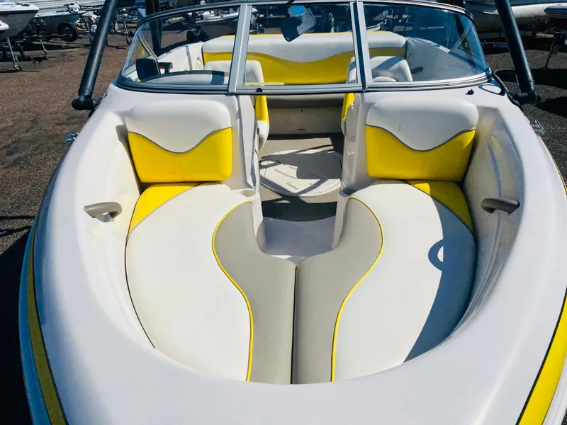Slide: The Image of 2006 Tahoe Q4 Sport boat interior with yellow and white seating. - 7