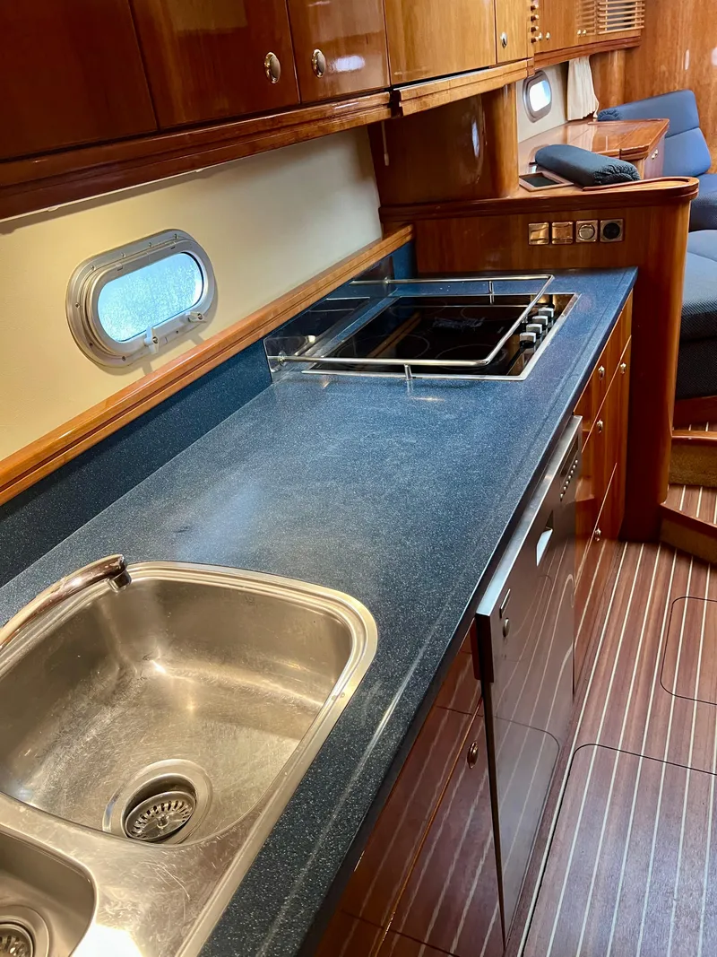 Slide: The Image of Galley kitchen in 2008 Elling E4 yacht with sink, stove, and wooden cabinetry. - 13