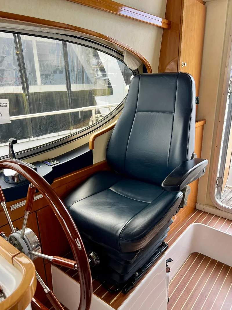Slide: The Image of Captain's chair in 2008 Elling E4 yacht cockpit, featuring leather upholstery and wooden accents. - 2