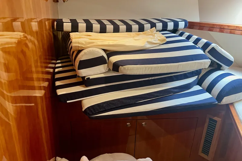 Slide: The Image of Striped cushions stacked inside a 2008 Elling E4 yacht interior. - 22