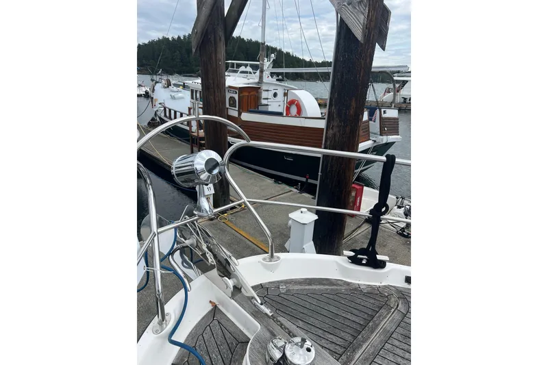 Slide: The Image of 2008 Elling E4 yacht docked at marina with wooden deck and railing. - 24