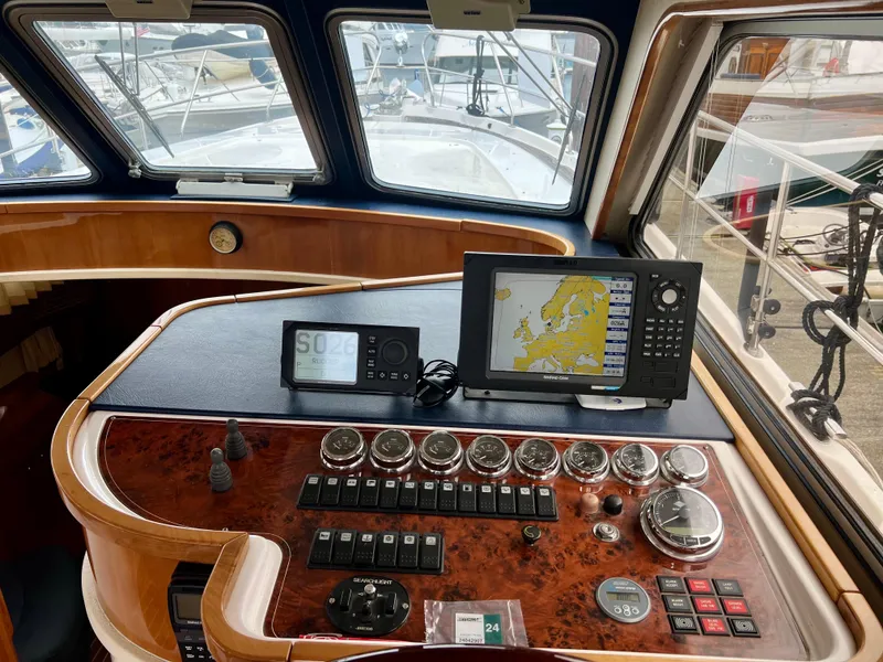 Slide: The Image of Control panel of a 2008 Elling E4 yacht with navigation equipment and gauges. - 3