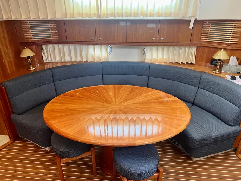 Slide: The Image of Luxurious Elling E4 2008 yacht interior with elegant wood table and curved seating. - 7