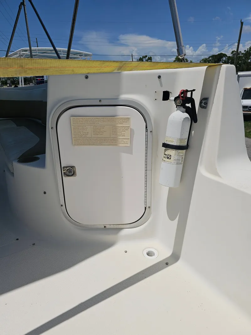 Slide: The Image of 1996 Bayliner 2609 Rendezvous boat interior with storage compartment and fire extinguisher. - 13