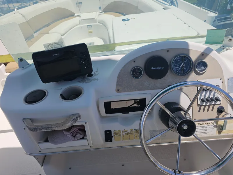 Slide: The Image of 1996 Bayliner 2609 Rendezvous boat dashboard with steering wheel and Garmin device. - 18