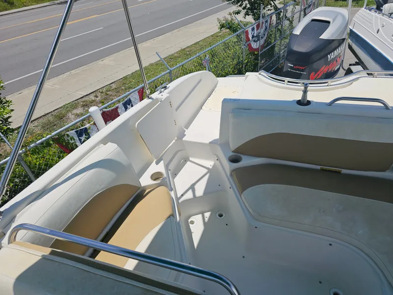 Slide: The Image of 1996 Bayliner 2609 Rendezvous boat interior with seating and cup holders. - 19
