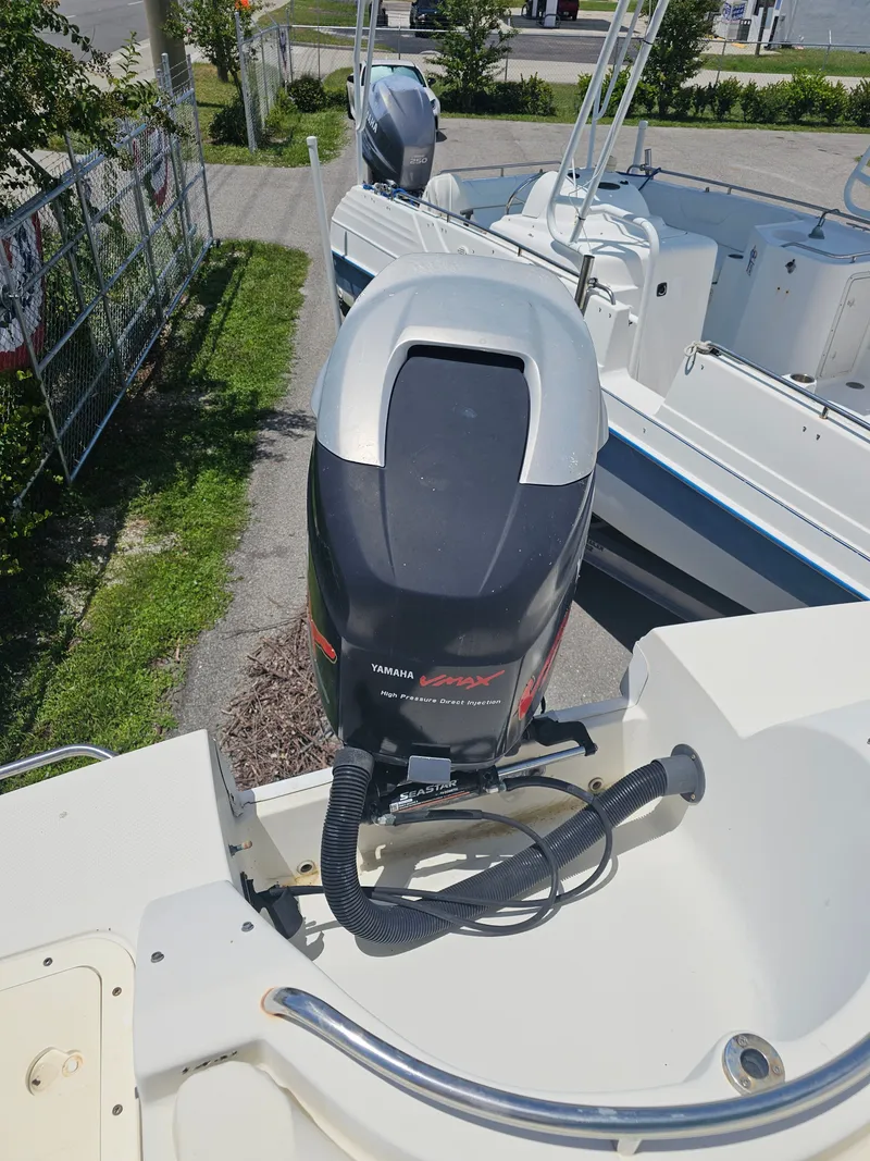 Slide: The Image of 1996 Bayliner 2609 Rendezvous with Yamaha VMAX outboard motor, parked outdoors. - 21