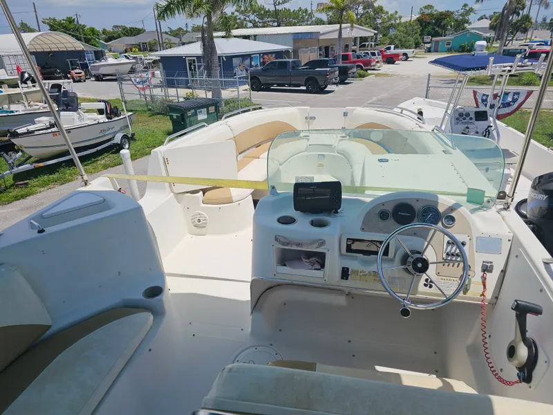 Slide: The Image of 1996 Bayliner 2609 Rendezvous boat interior with steering wheel and seating area. - 23