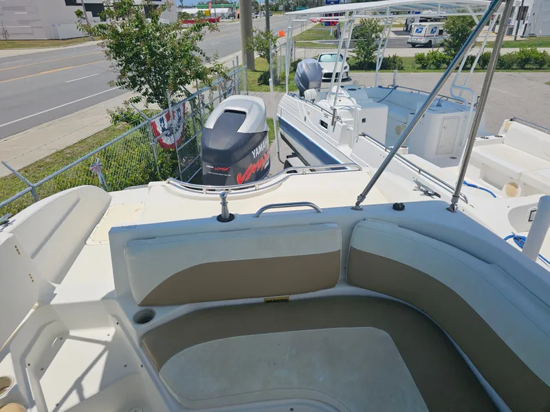 Slide: The Image of 1996 Bayliner 2609 Rendezvous boat with Yamaha outboard motor, parked near a road. - 24