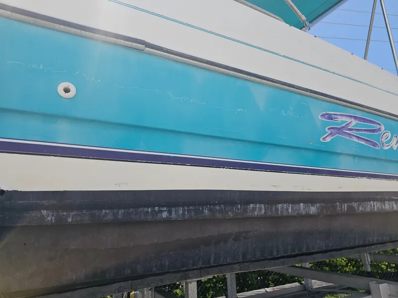 Slide: The Image of 1996 Bayliner 2609 Rendezvous boat with blue and white hull on a trailer. - 27