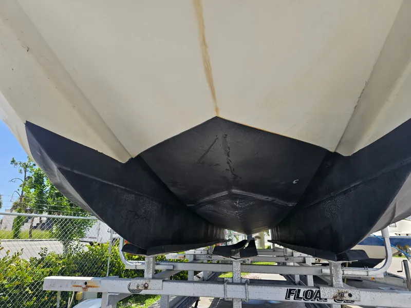 Slide: The Image of Bayliner 2609 Rendezvous 1996 boat hull on trailer, showcasing underside and structure. - 28