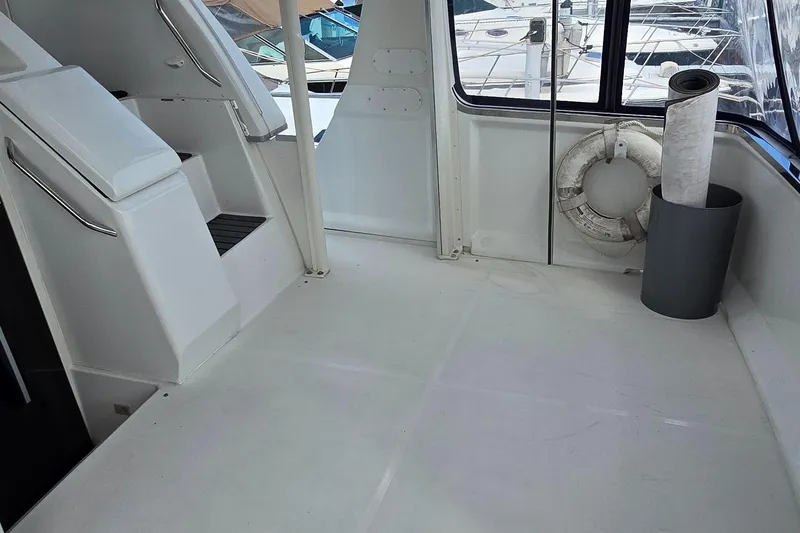 Slide: The Image of 2000 Carver 356 Aft Cabin Motor Yacht interior with seating and life preserver. - 13