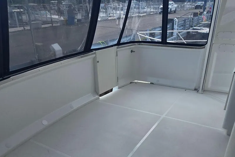 Slide: The Image of 2000 Carver 356 Aft Cabin Motor Yacht interior with large windows and spacious seating area. - 14