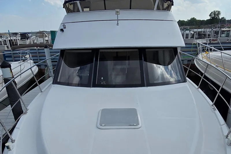 Slide: The Image of 2000 Carver 356 Aft Cabin Motor Yacht docked at marina, front view. - 2