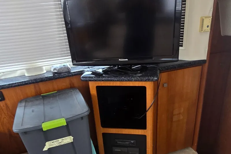 Slide: The Image of Interior of 2000 Carver 356 Aft Cabin Motor Yacht with TV and storage bin. - 20