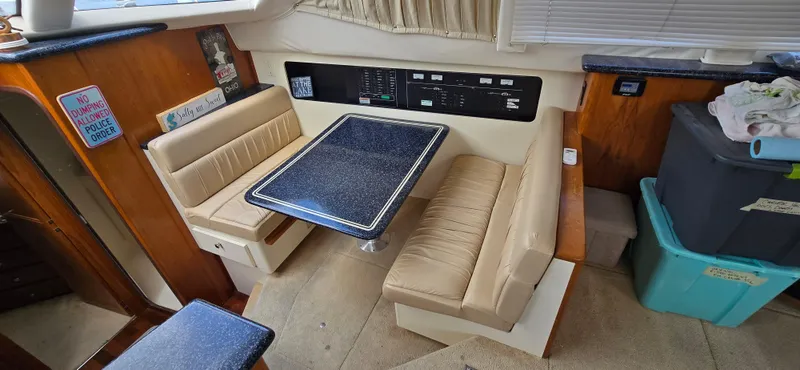 Slide: The Image of Interior of 2000 Carver 356 Aft Cabin Motor Yacht with dining area and control panel. - 21