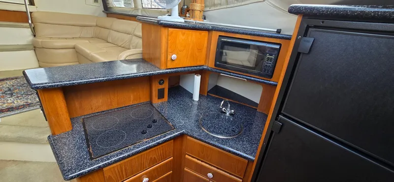Slide: The Image of Interior of 2000 Carver 356 Aft Cabin Motor Yacht with kitchenette and seating area. - 22