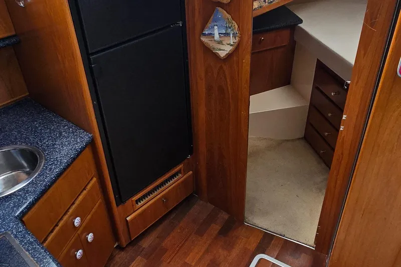 Slide: The Image of Interior of 2000 Carver 356 Aft Cabin Motor Yacht with kitchenette and cabin entrance. - 23