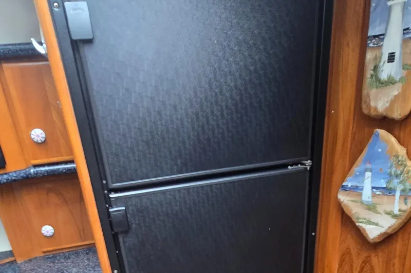 Slide: The Image of Interior of 2000 Carver 356 Aft Cabin Motor Yacht with fridge and nautical decor. - 24