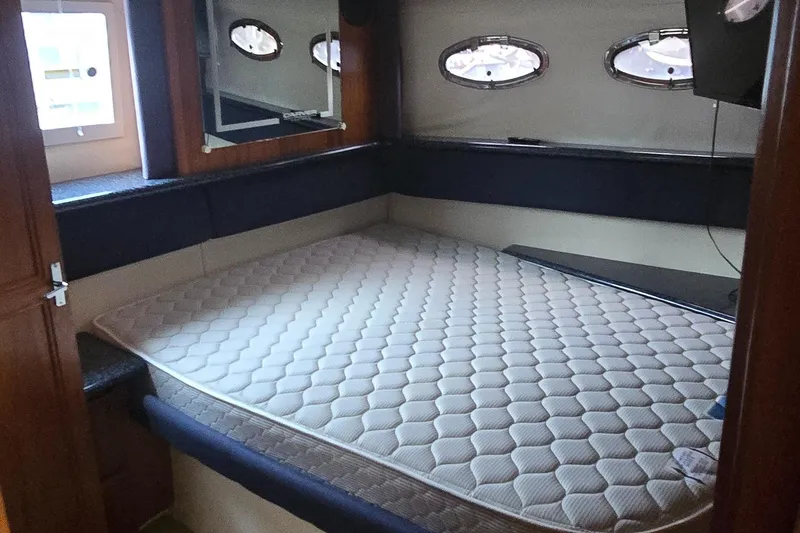 Slide: The Image of Interior cabin of 2000 Carver 356 Aft Cabin Motor Yacht with bed and portholes. - 27