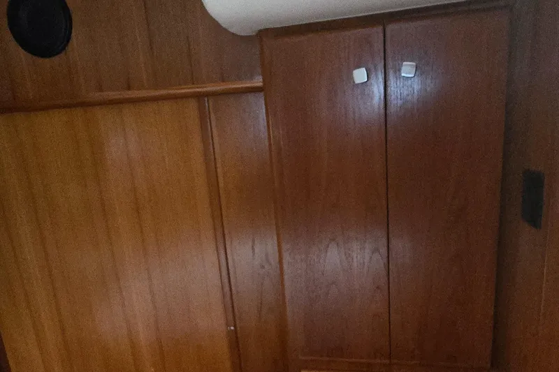 Slide: The Image of Wooden interior of 2000 Carver 356 Aft Cabin Motor Yacht, featuring cabinets and paneling. - 28