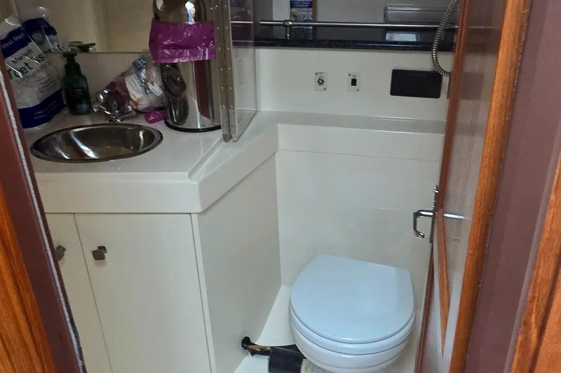 Slide: The Image of Bathroom interior of 2000 Carver 356 Aft Cabin Motor Yacht, featuring sink and toilet. - 29