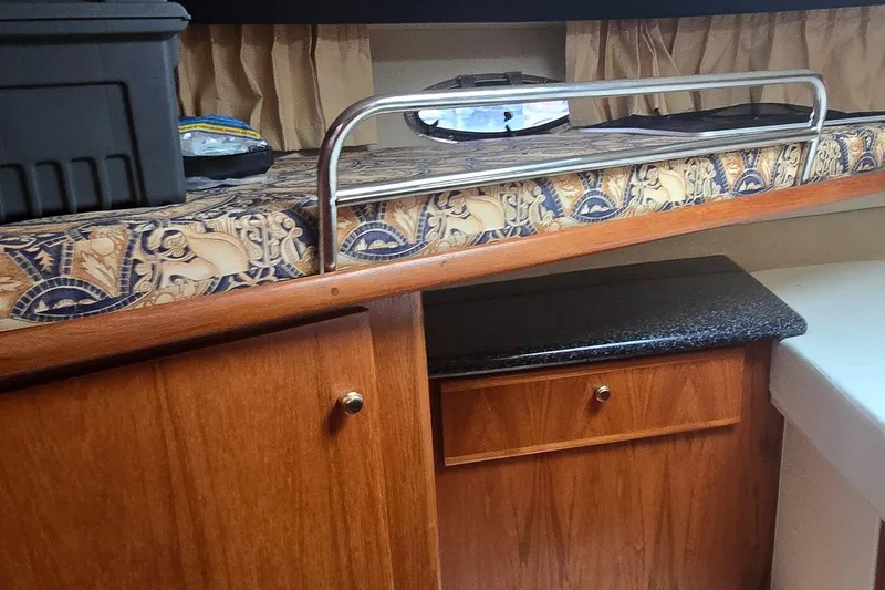 Slide: The Image of Interior of 2000 Carver 356 Aft Cabin Motor Yacht with wood cabinetry and patterned upholstery. - 32