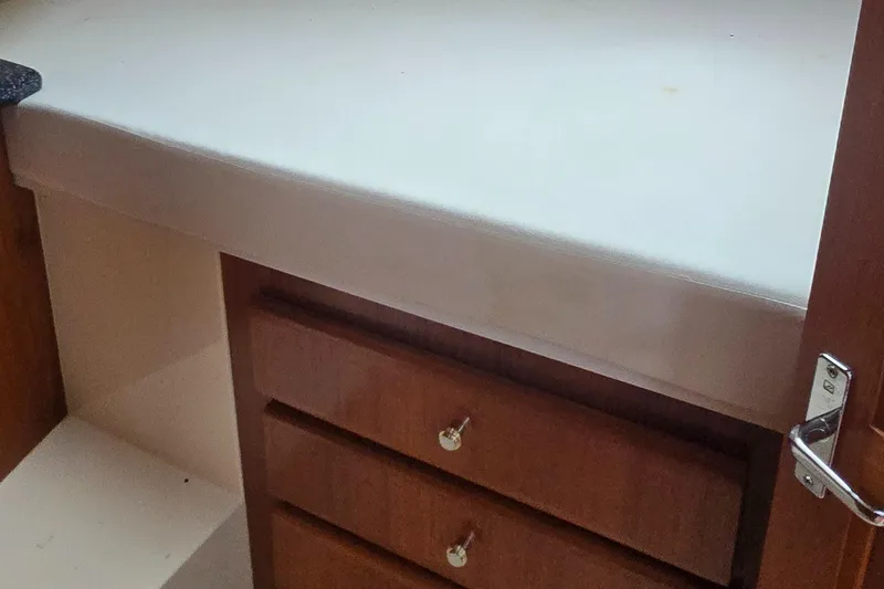 Slide: The Image of Interior of 2000 Carver 356 Aft Cabin Motor Yacht with wooden drawers and white countertop. - 33