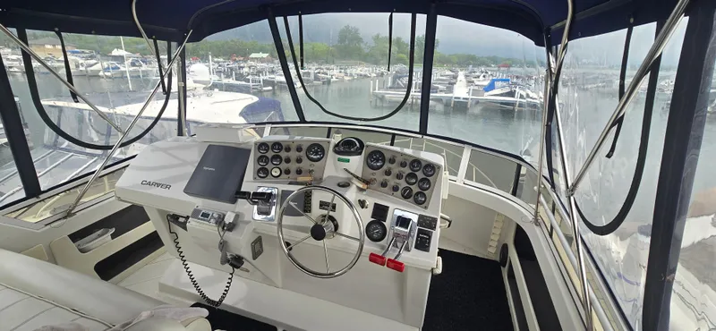 Slide: The Image of Helm of 2000 Carver 356 Aft Cabin Motor Yacht at marina, featuring navigation controls. - 4