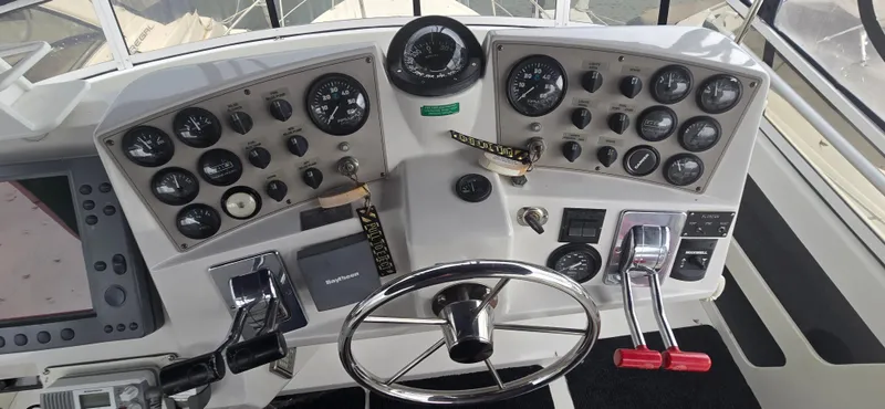 Slide: The Image of Control panel of 2000 Carver 356 Aft Cabin Motor Yacht with gauges and steering wheel. - 5